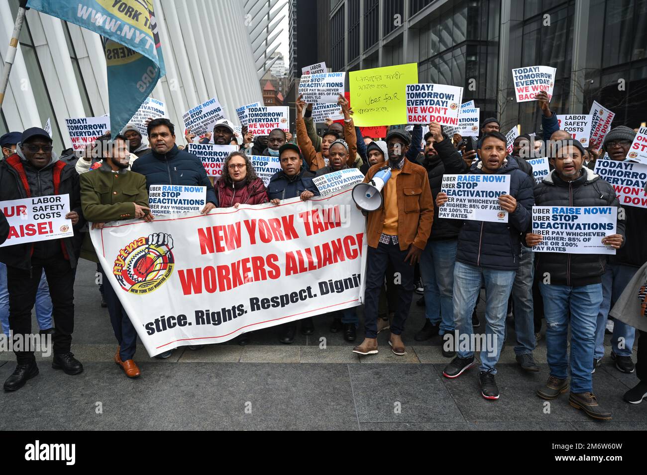 Uber drivers participate in a rally outside of the Uber Headquarters on
