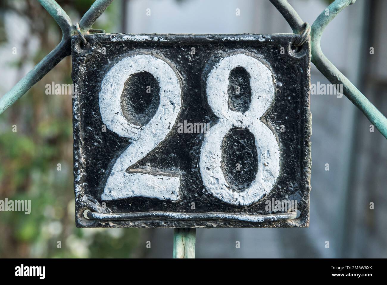 Old retro cast iron plate number 28 closeup Stock Photo