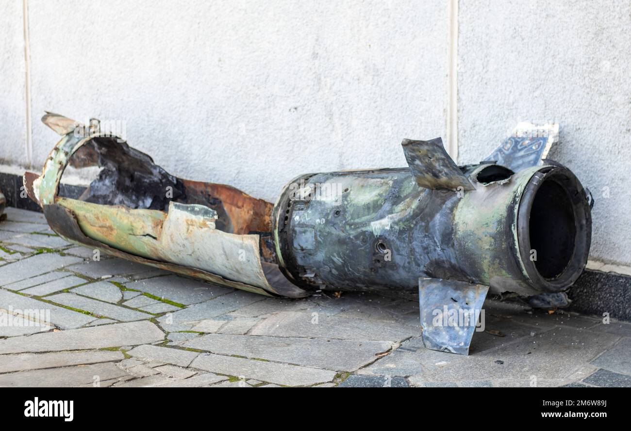 A metal fragment of a military rocket lies on the ground after the ...