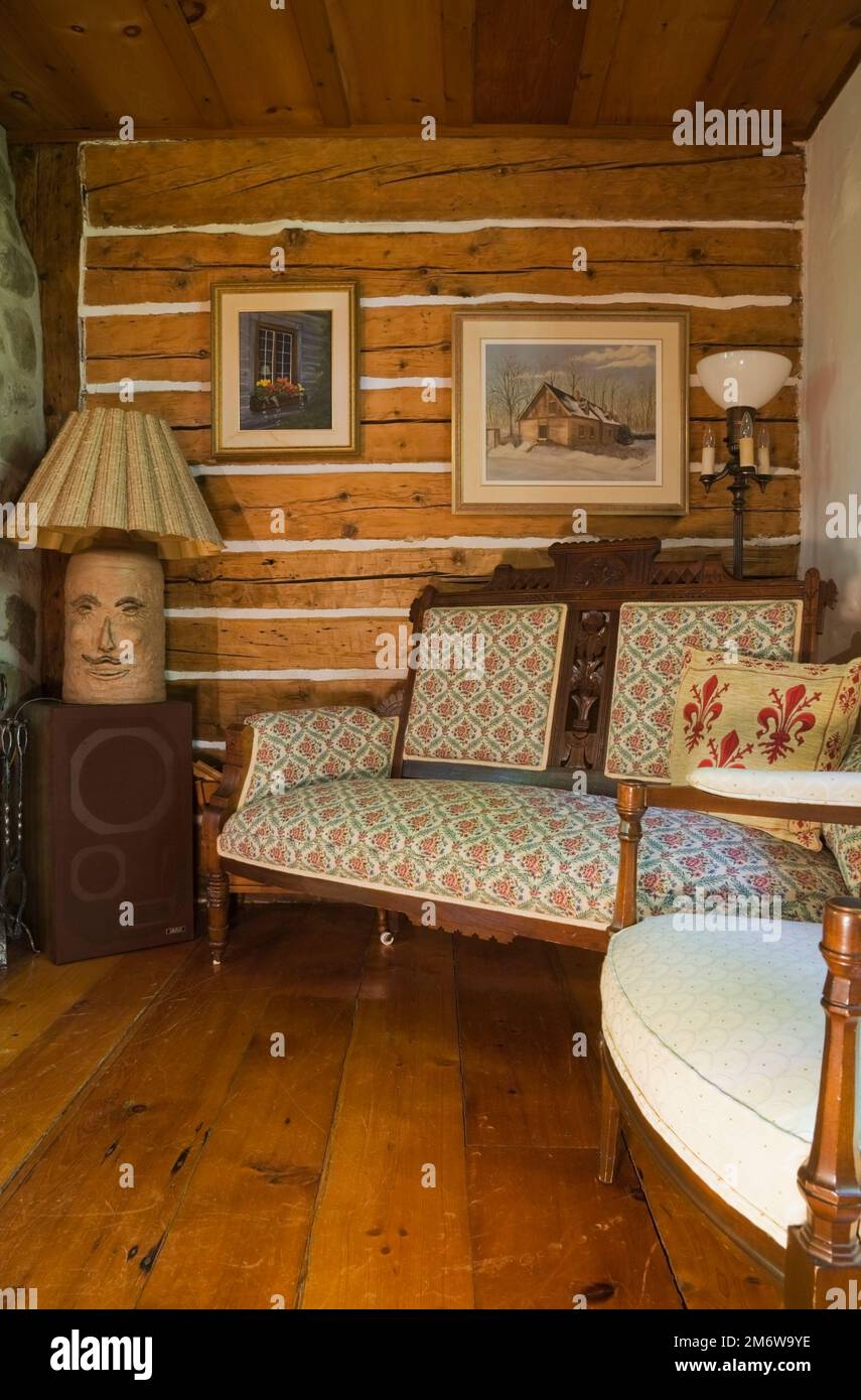 Upholstered armchair and sofa in living room inside 1980 reconstructed log  home Stock Photo - Alamy, image size:855x1390