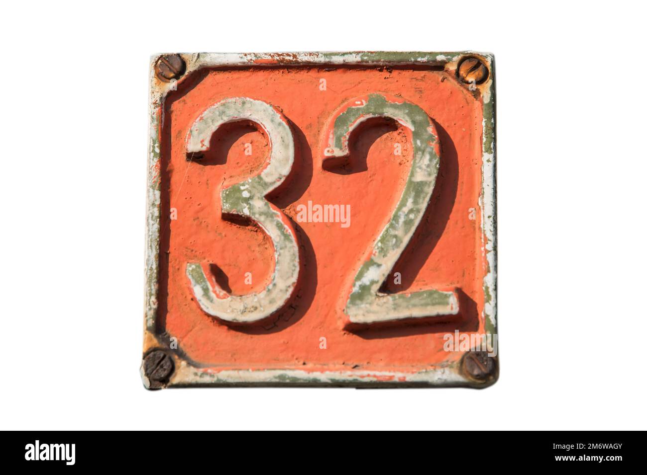 Old retro weathered cast iron plate with number 32 closeup isolated on white background Stock Photo