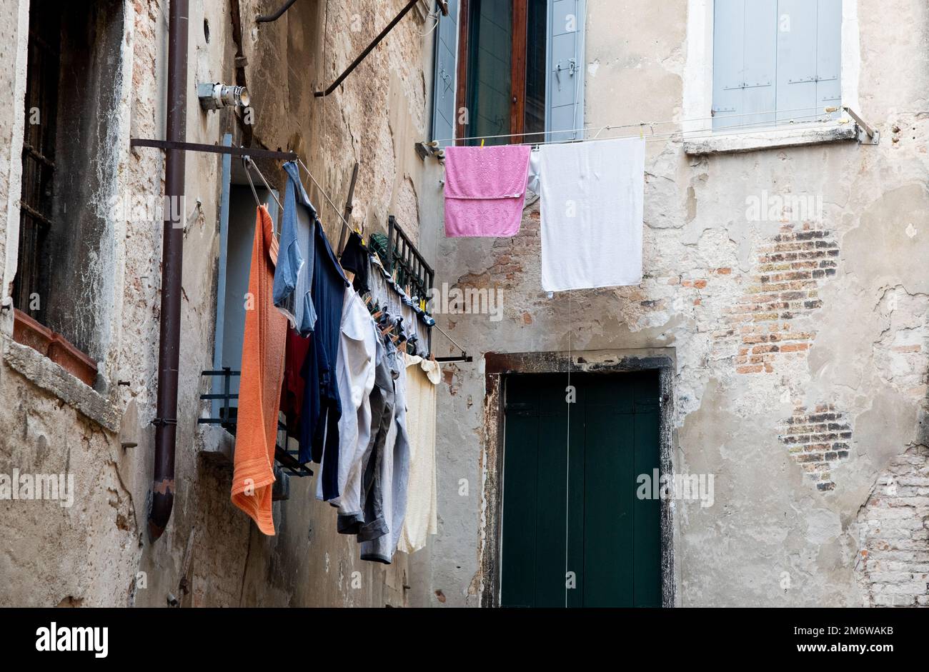Home laundry hanging on a rope and drying outdoor in the clean air saving the environment. Stock Photo