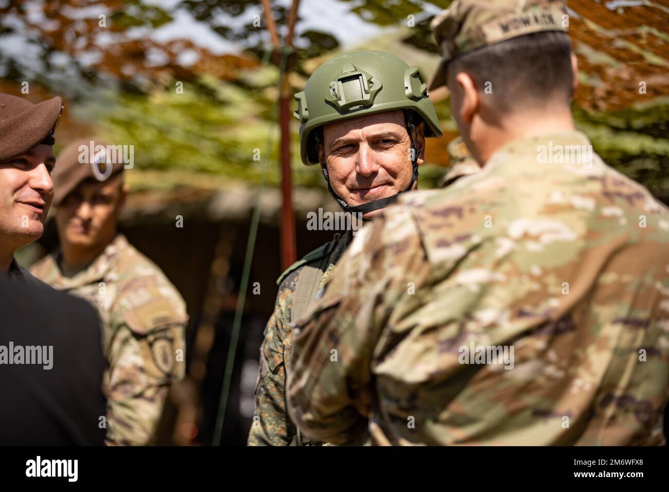 U.S. Army Brig. Gen. David Womack, incoming Fifth Corps deputy commanding general of maneuver, talks to Bulgarian Land Forces Lt. Col. Velin Kohayev, commander of 42nd Mechanized Battalion, during a Bulgaria Armed Forces Day celebration, at Novo Selo Training Area, Bulgaria, May 6, 2022. V Corps, America's Forward Deployed Corps in Europe, works alongside NATO Allies and regional security partners, like Bulgaria, to provide combat-ready forces, execute joint and multinational training exercises, and retain command and control for all rotational and assigned units in the European theater. Stock Photo