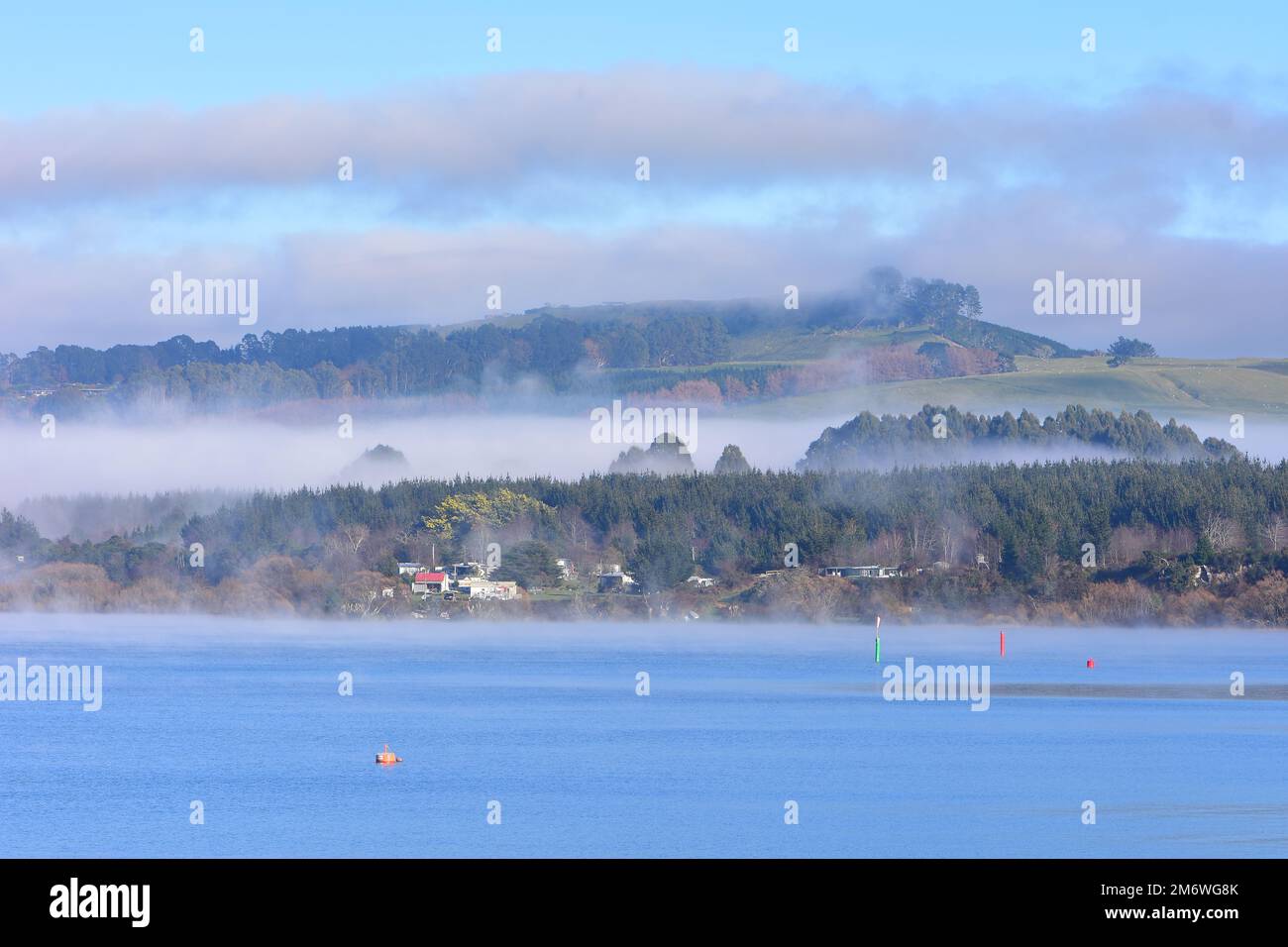 Morning fog covering shores around Lake Taupo. Location: Taupo New Zealand Stock Photo