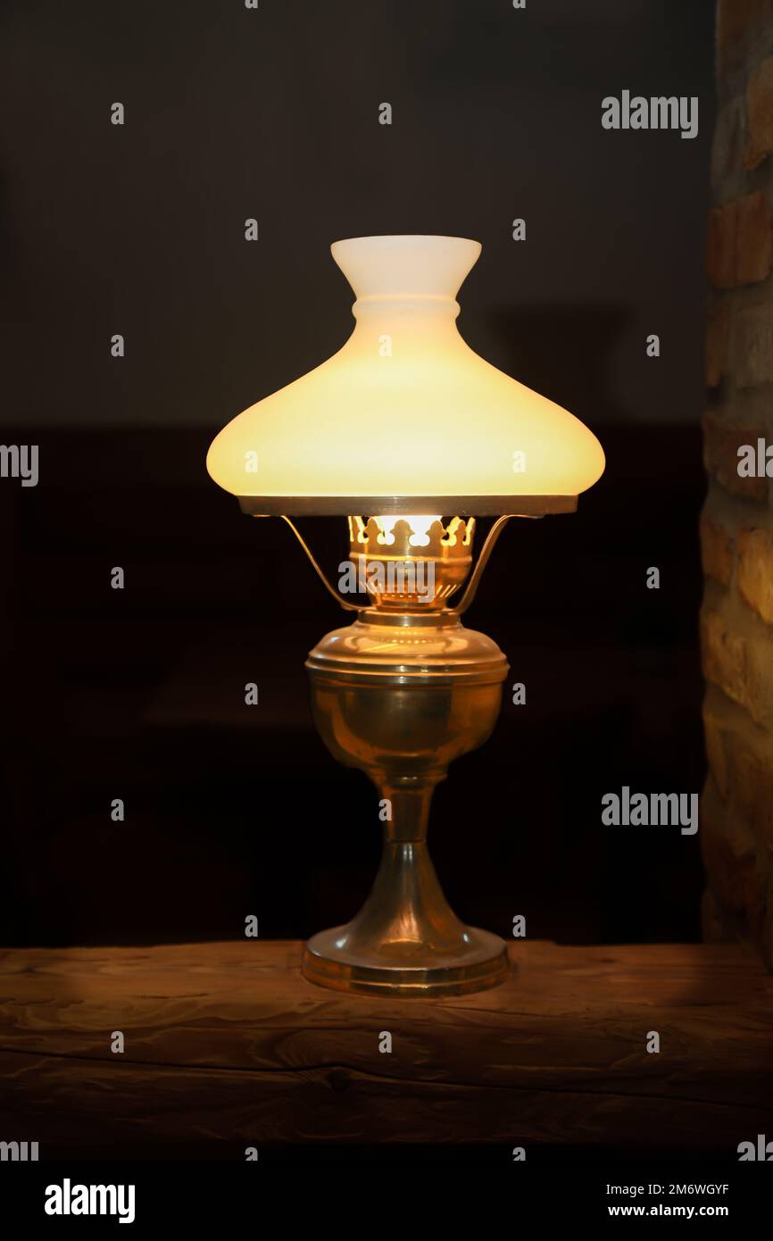 A floor lamp on a base made of a wooden post. Stock Photo
