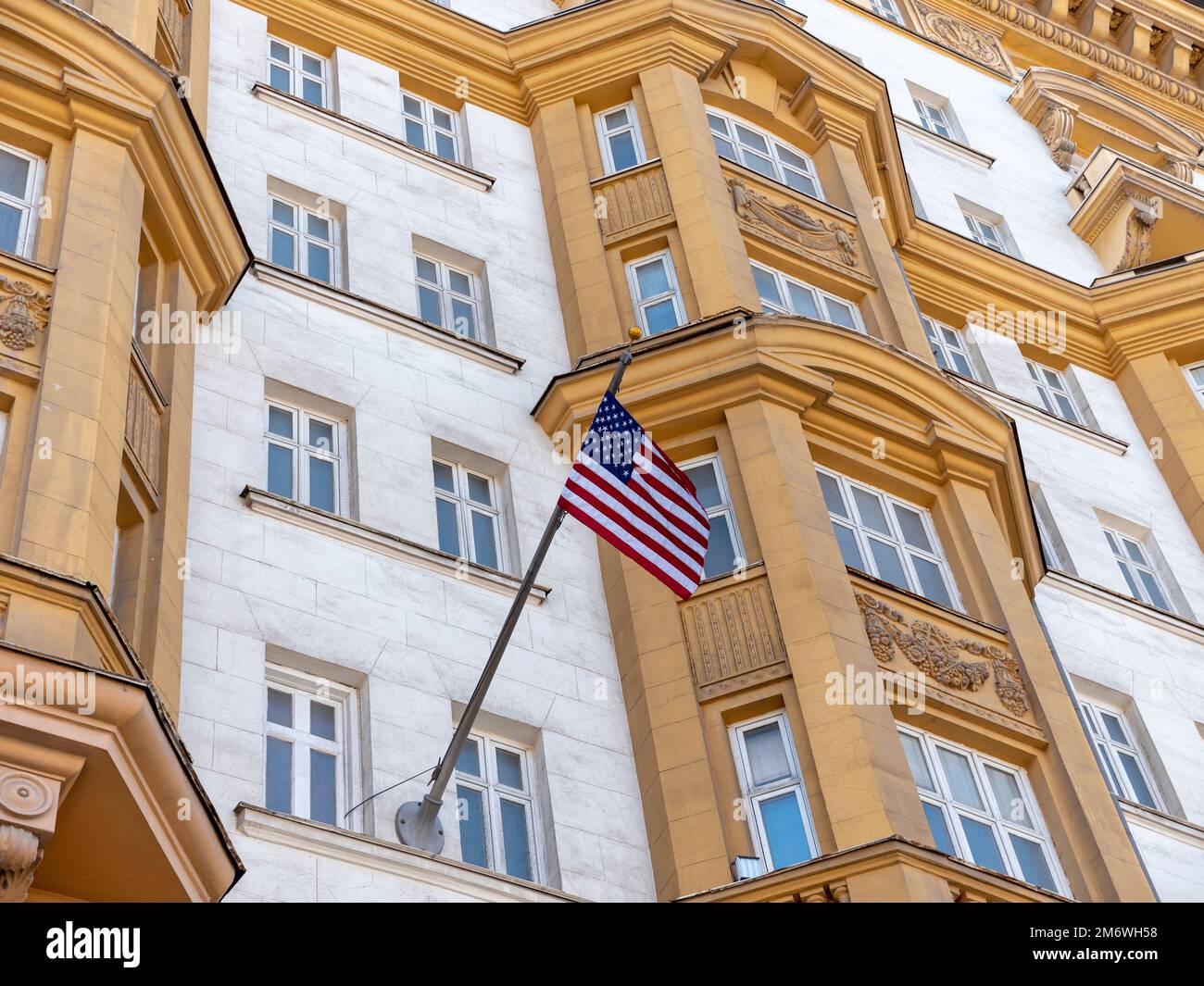 Wrapped around flagpole flag of the USA in Russia Moscow Stock Photo