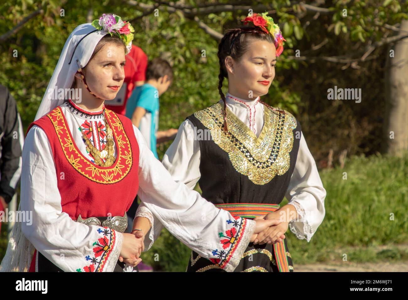 Bulgarian locals dressed in Nosiya, or traditional garments, perform a