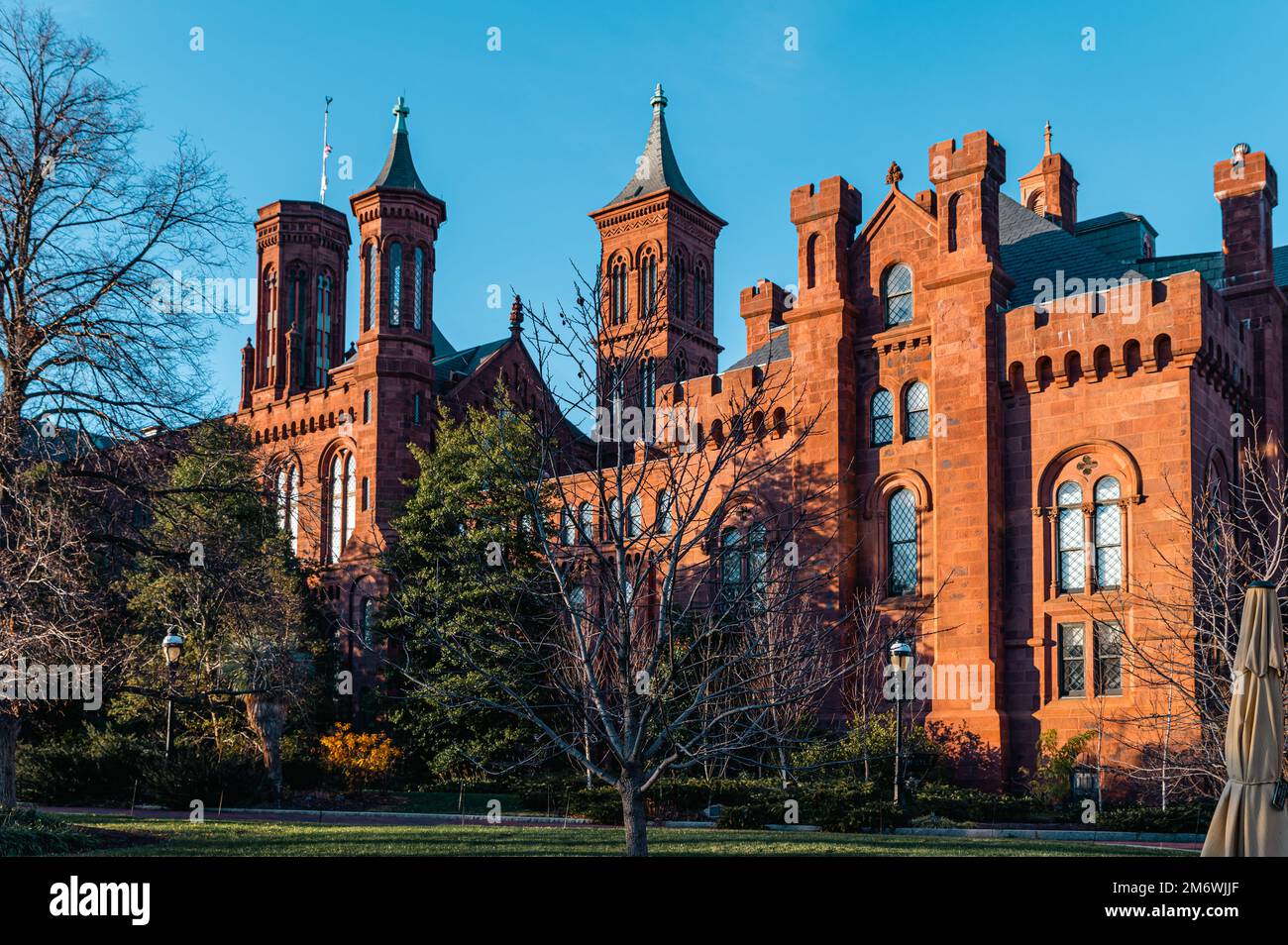 Sunny day shot of the side view of the Smithsonian Castle. It houses the Smithsonian Institution’s administrative offices and information center. Stock Photo