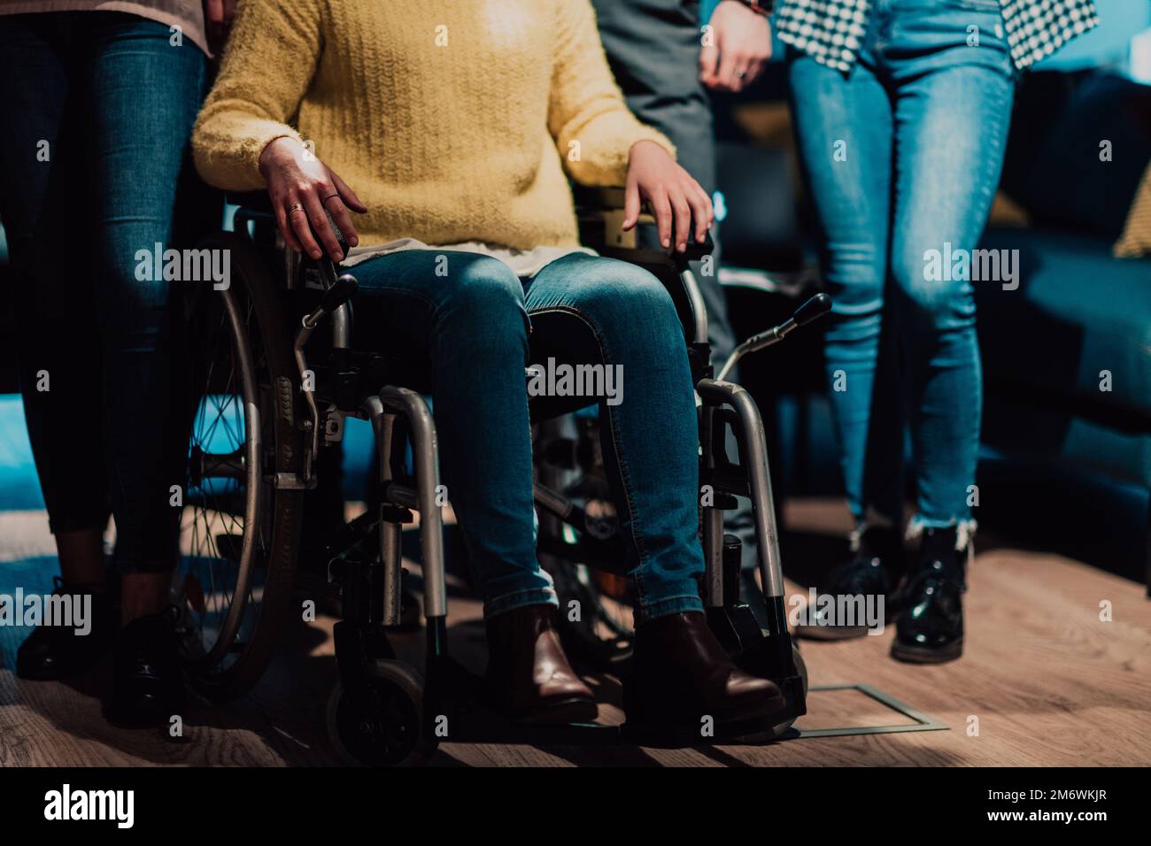 Close up photo of a woman with a disability sitting in a wheelchair in the office Stock Photo