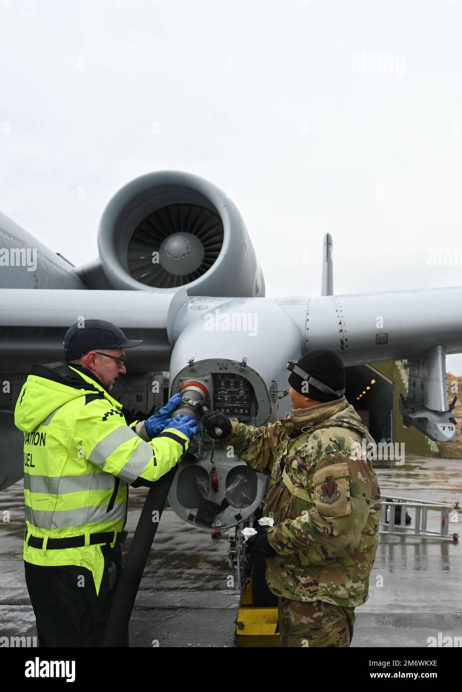 A Norwegian Aviation Fuel Specialist (left) and U.S. Air Force Staff