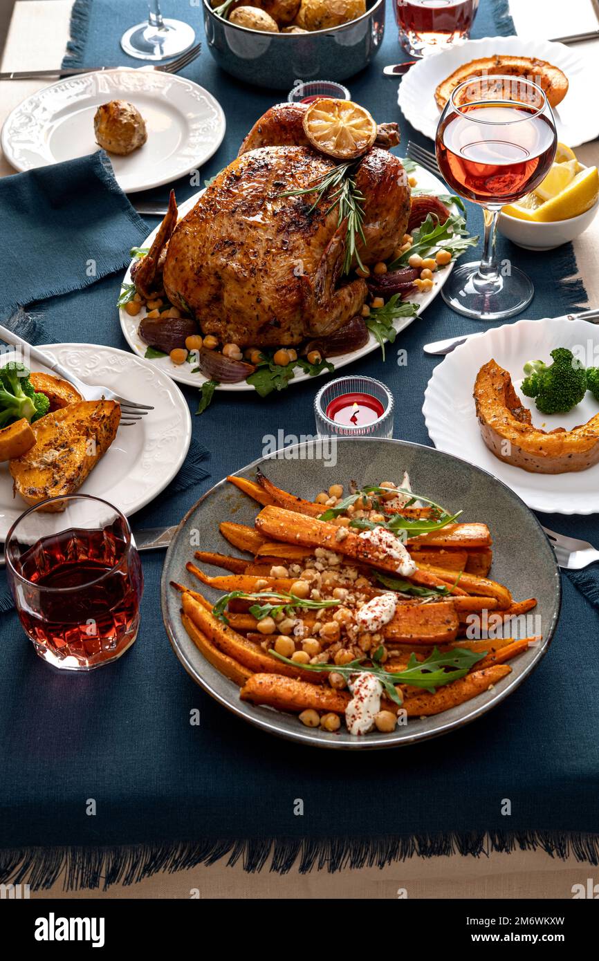 Traditional holiday dinner for celebration Thanksgiving. Baked chicken, potatoes and sides. Family party or gathering. Fall tabl Stock Photo