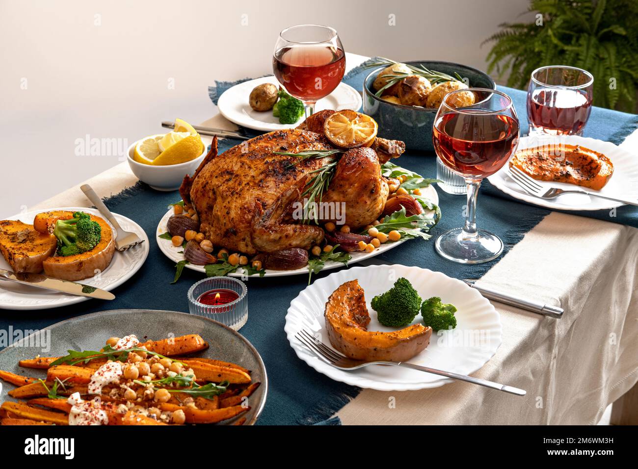 Traditional holiday dinner for celebration Thanksgiving. Baked chicken, potatoes and sides. Family party or gathering. Fall tabl Stock Photo