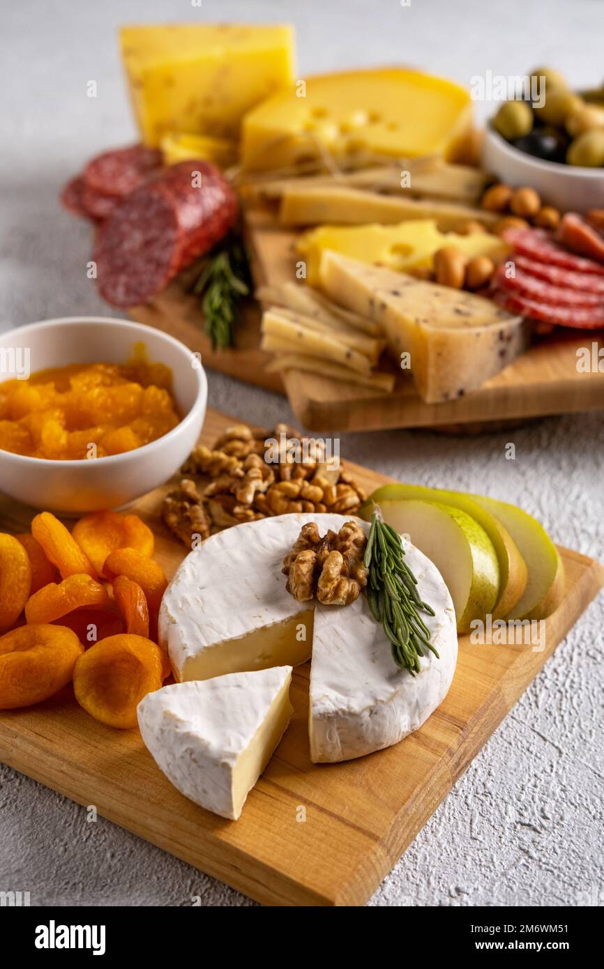 Different types of cheeses and cold cut meats. Top view on a white