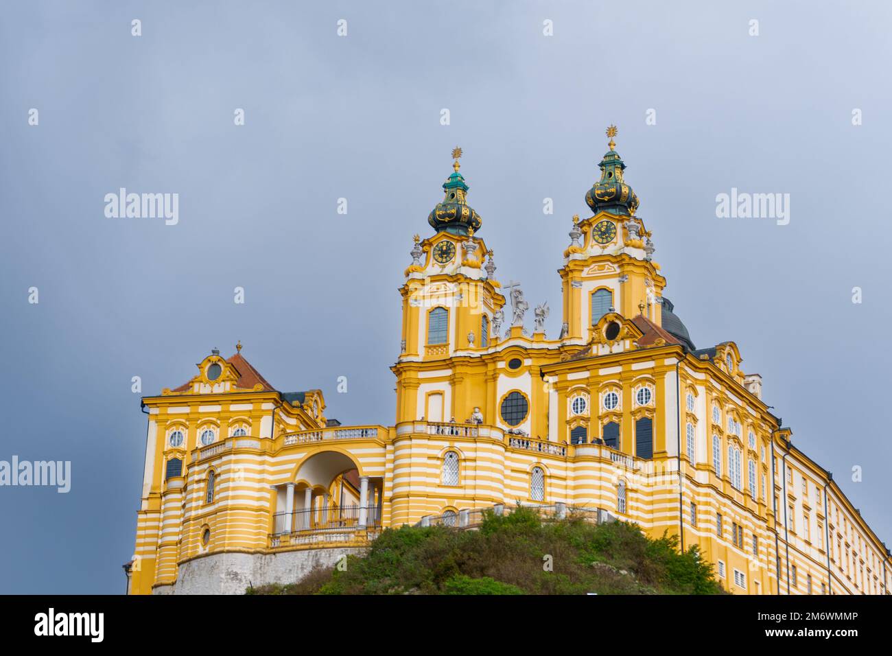 The historic Melk Abbey and church spires on the rocky promontory above the Danube River Stock Photo