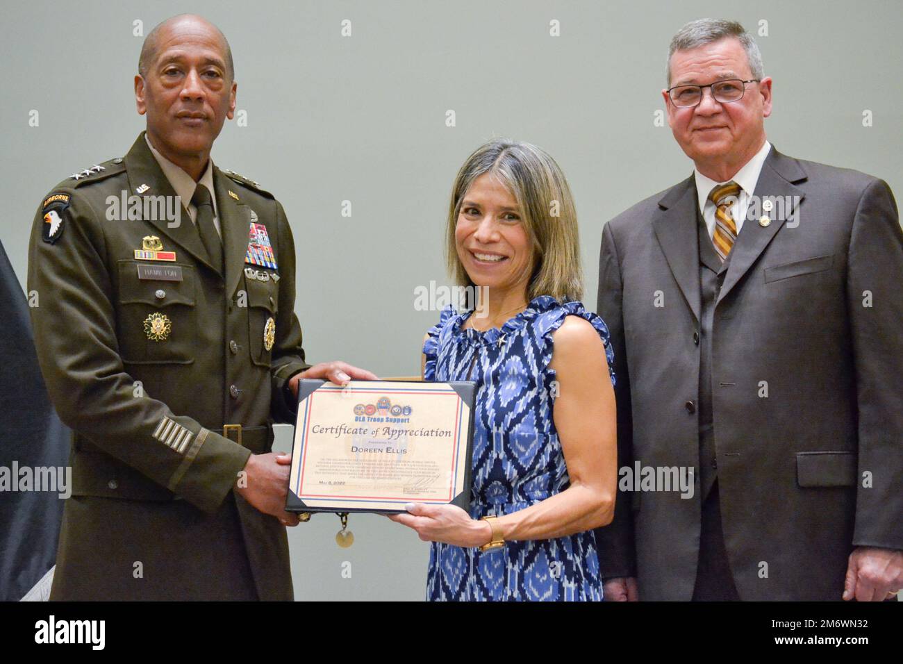 Doreen Ellis, center, receives a commander’s certificate of appreciation from Army Lt. Gen. Charles R. Hamilton, deputy chief of staff, G-4, during a retirement ceremony May 6, as DLA Troop Support Deputy Commander Richard Ellis looks on during his retirement ceremony May 6. Ellis retired after 38 years of federal service, 26 in the Navy and 12 at Troop Support. Stock Photo