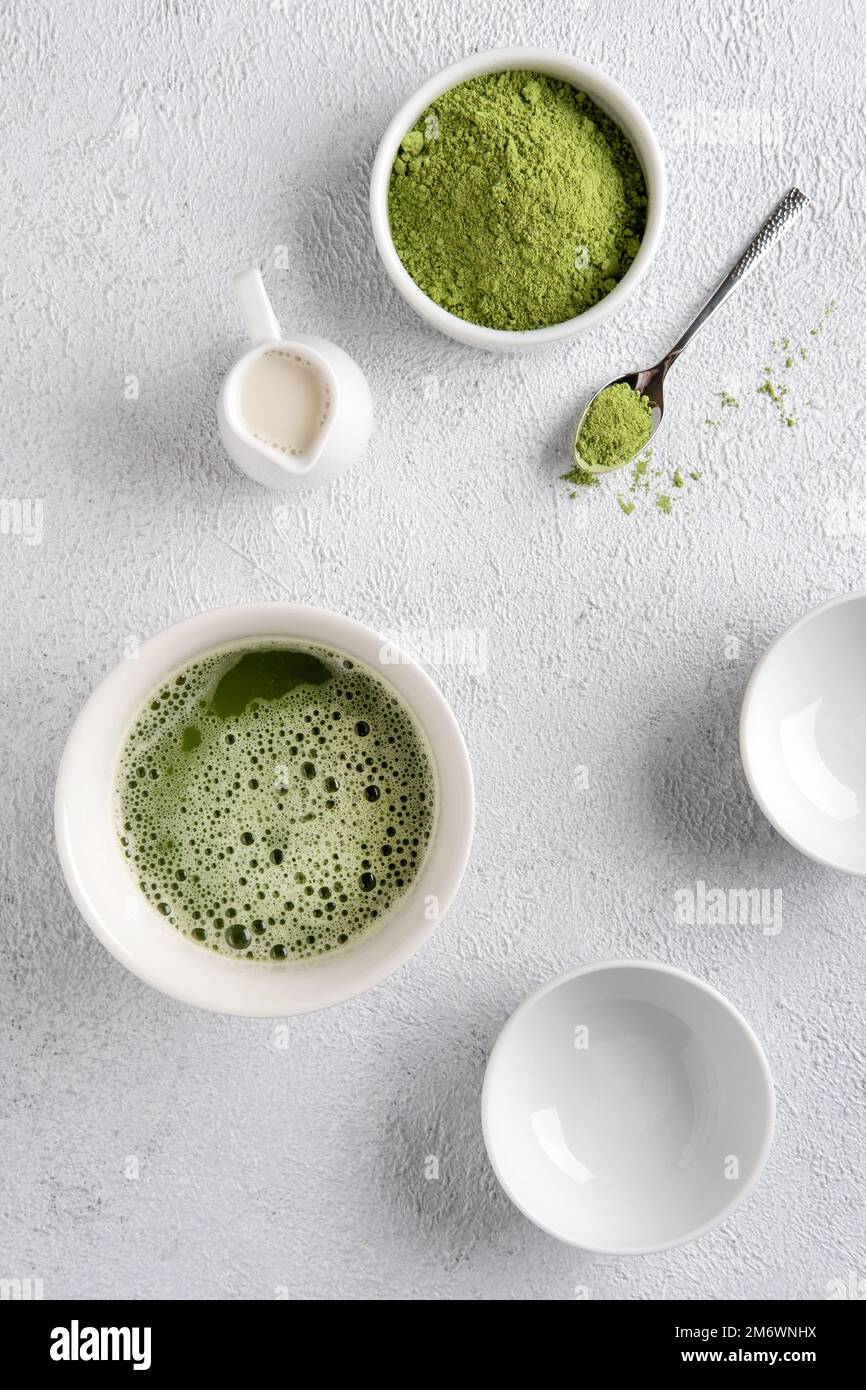 Matcha tea powder on gray concrete background. Tea ceremony. Healthy drink. Traditional japanese drink. Stock Photo