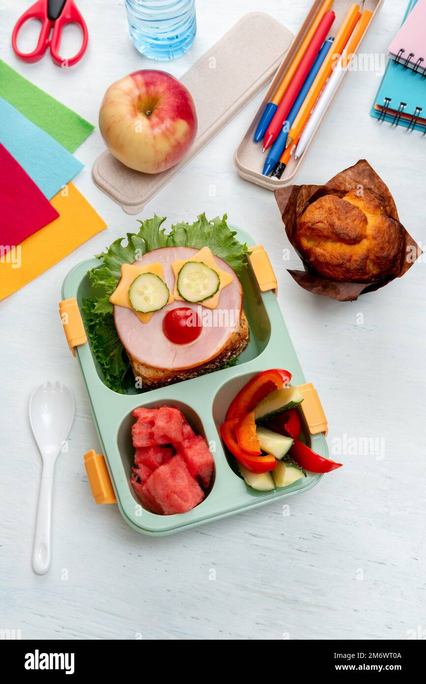 School lunch box for kids with food in the form of funny faces. School