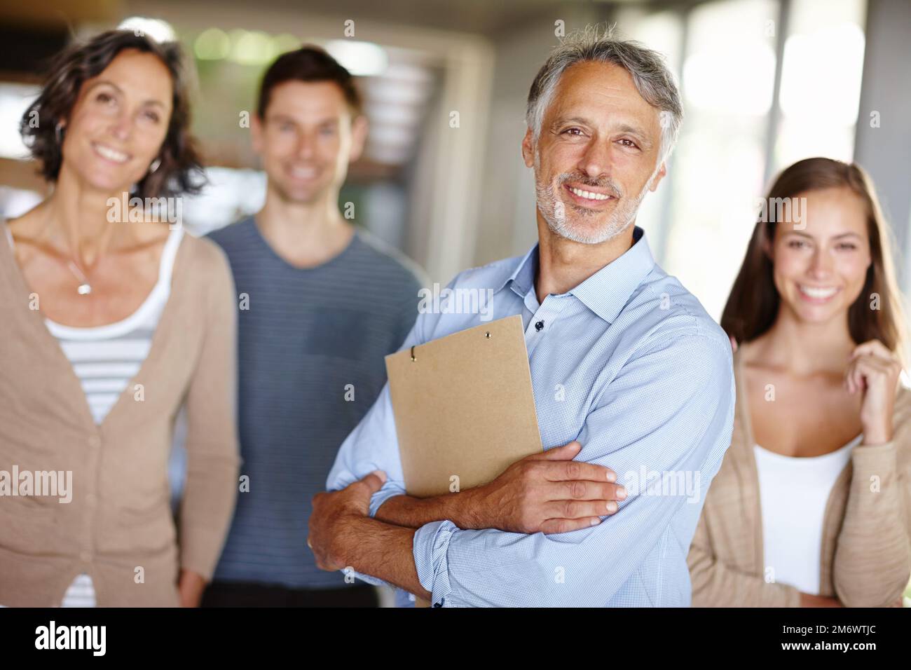 Family comes first. Portrait of two happy parents with their adult children at home. Stock Photo