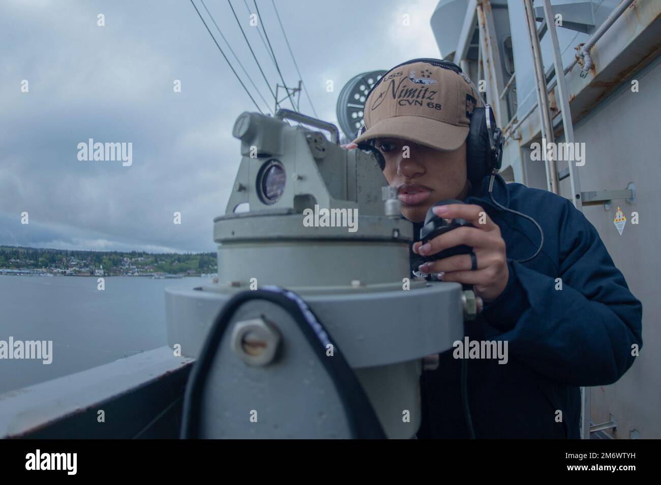 220507-N-KU796-1043 PUGET SOUND WASH., (May 07, 2022) Quartermaster Seaman Gaea Kohles, from Savannah, Ga., uses a telescopic alidade to locate navigational aids as the aircraft carrier USS Nimitz (CVN 68) gets underway. Nimitz is underway conducting routine operations. Stock Photo