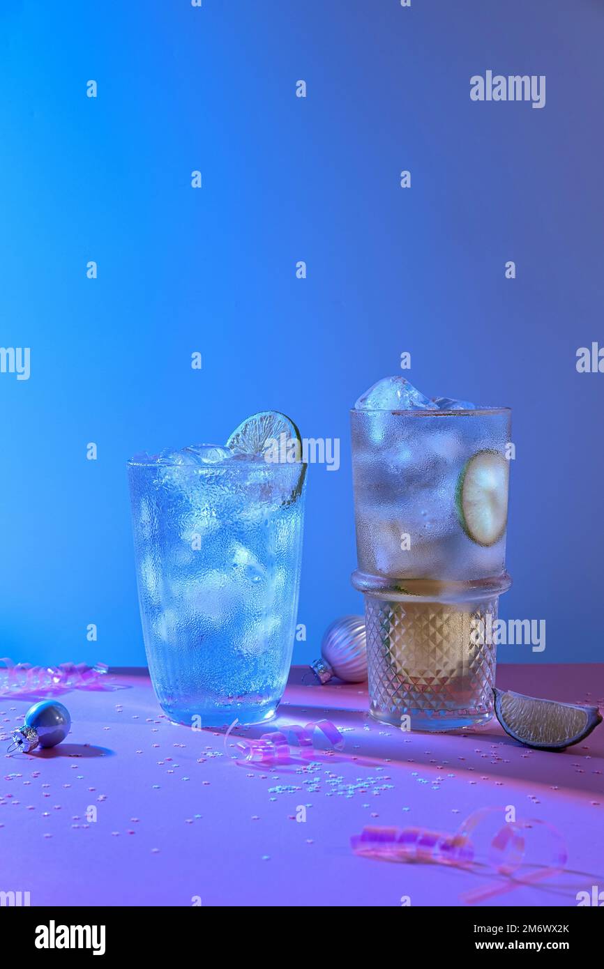 Two vibrant and sparkling alcoholic punch is perfect for Christmas party. Colorful cocktails in glasses.  Fresh holiday drinks. Stock Photo