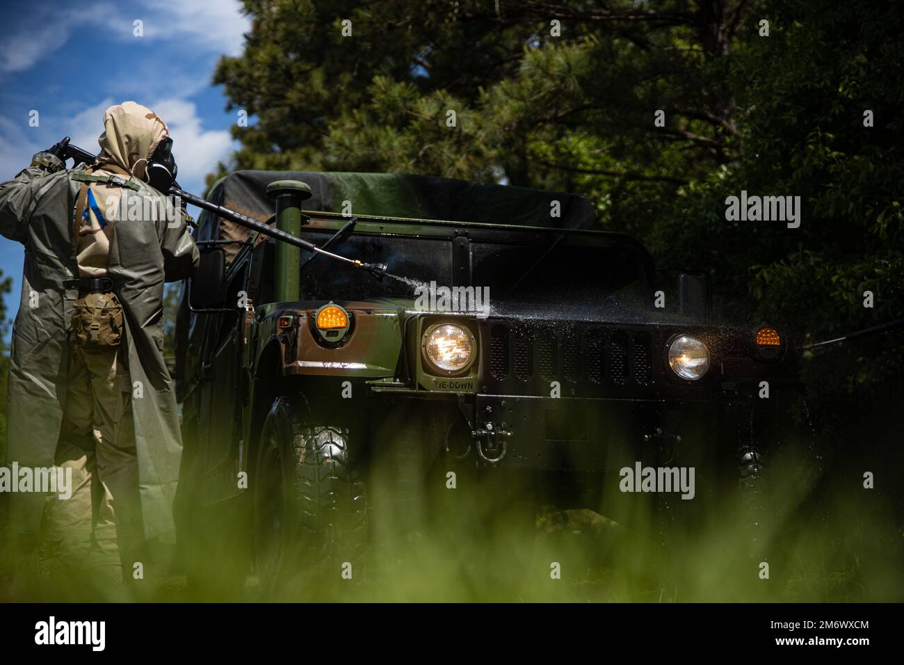 A U.S. Marine Corps humvee used by Combat Logistics Regiment 27, 2nd Marine Logistics Group, is sprayed with a general purpose decontaminate during Potomac Restore, a regimental exercise, at Camp Lejeune, North Carolina, May 7, 2022. This portion of Potomac Restore was utilized to enhance Marines’ and Sailors’ experience in recognizing and defending against simulated CBRN attacks. Stock Photo