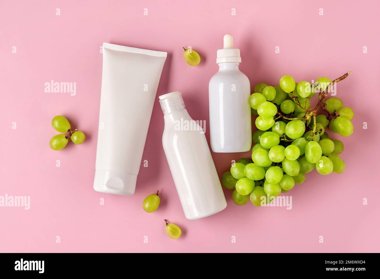 Three white mock up bottles for branding with grape seed oil. Skincare