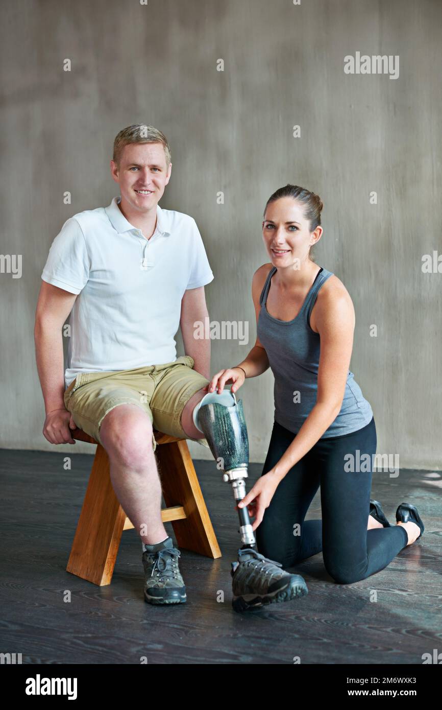 Focused on fitness. a female physiotherapist having a session with a young male amputee. Stock Photo