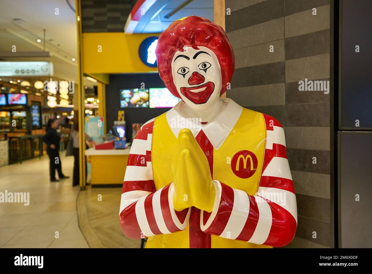 BANGKOK, THAILAND - CIRCA JANUARY, 2020: life size Ronald McDonald statue greeting customers with the traditional thai greeting at McDonald's restaura Stock Photo