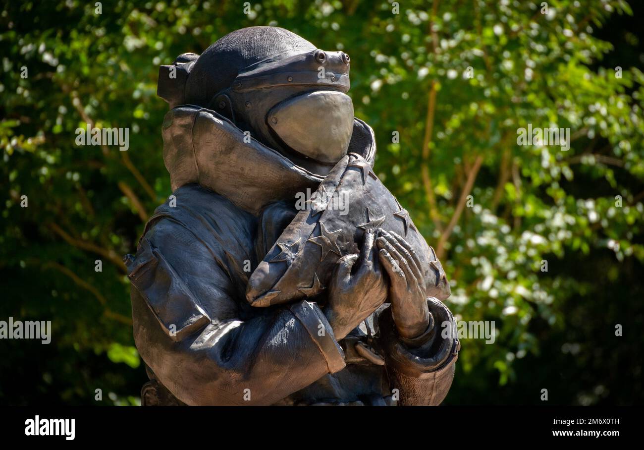 A bombsuited explosive ordnance disposal warrior statue clutching an