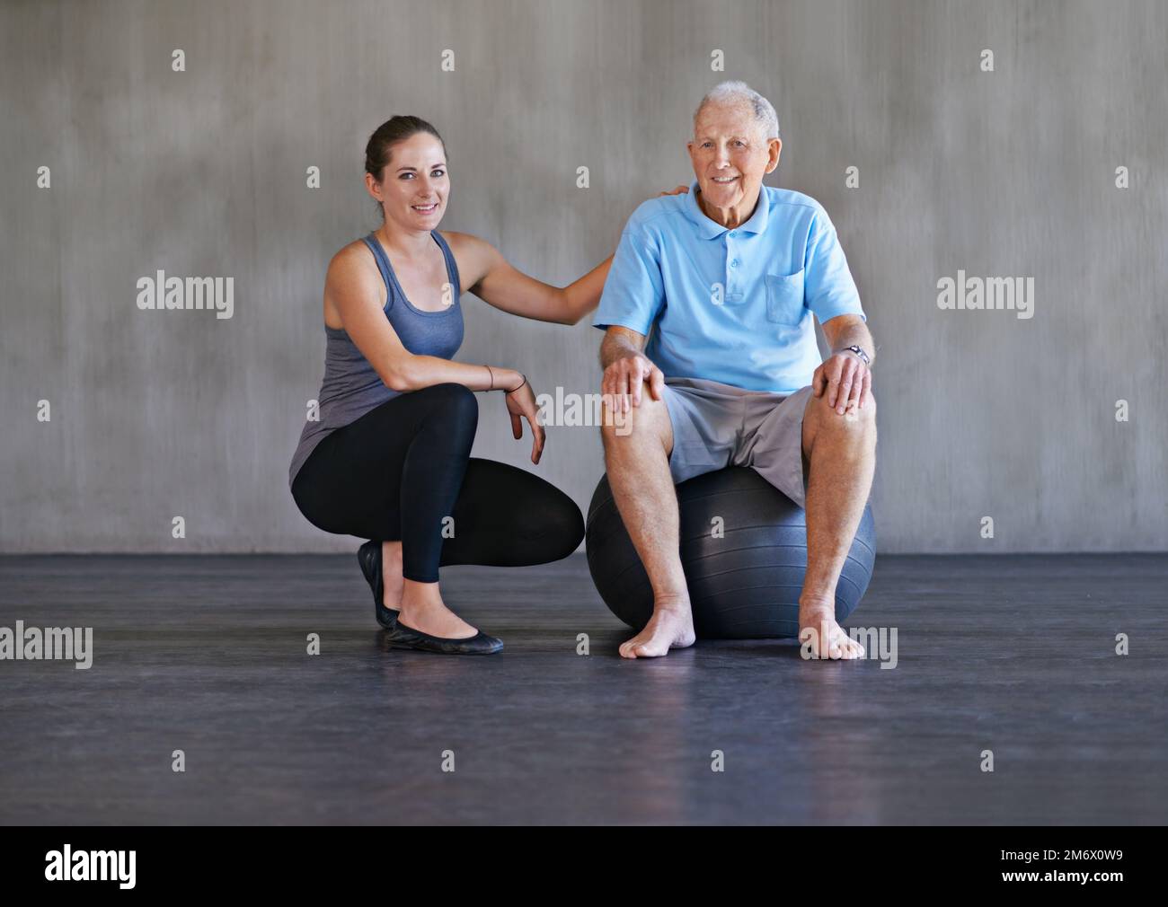 Hell be healthier in no time. a a physical therapist working with a senior man. Stock Photo
