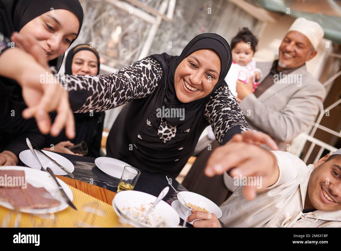 Theres enough for everyone. a muslim family eating together. Stock Photo