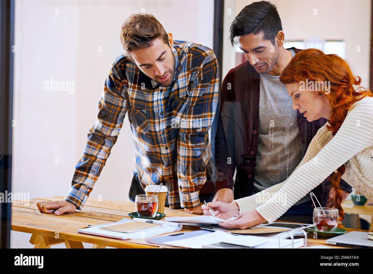 Combining their creative powers. a team of young designers working together in their office. Stock Photo