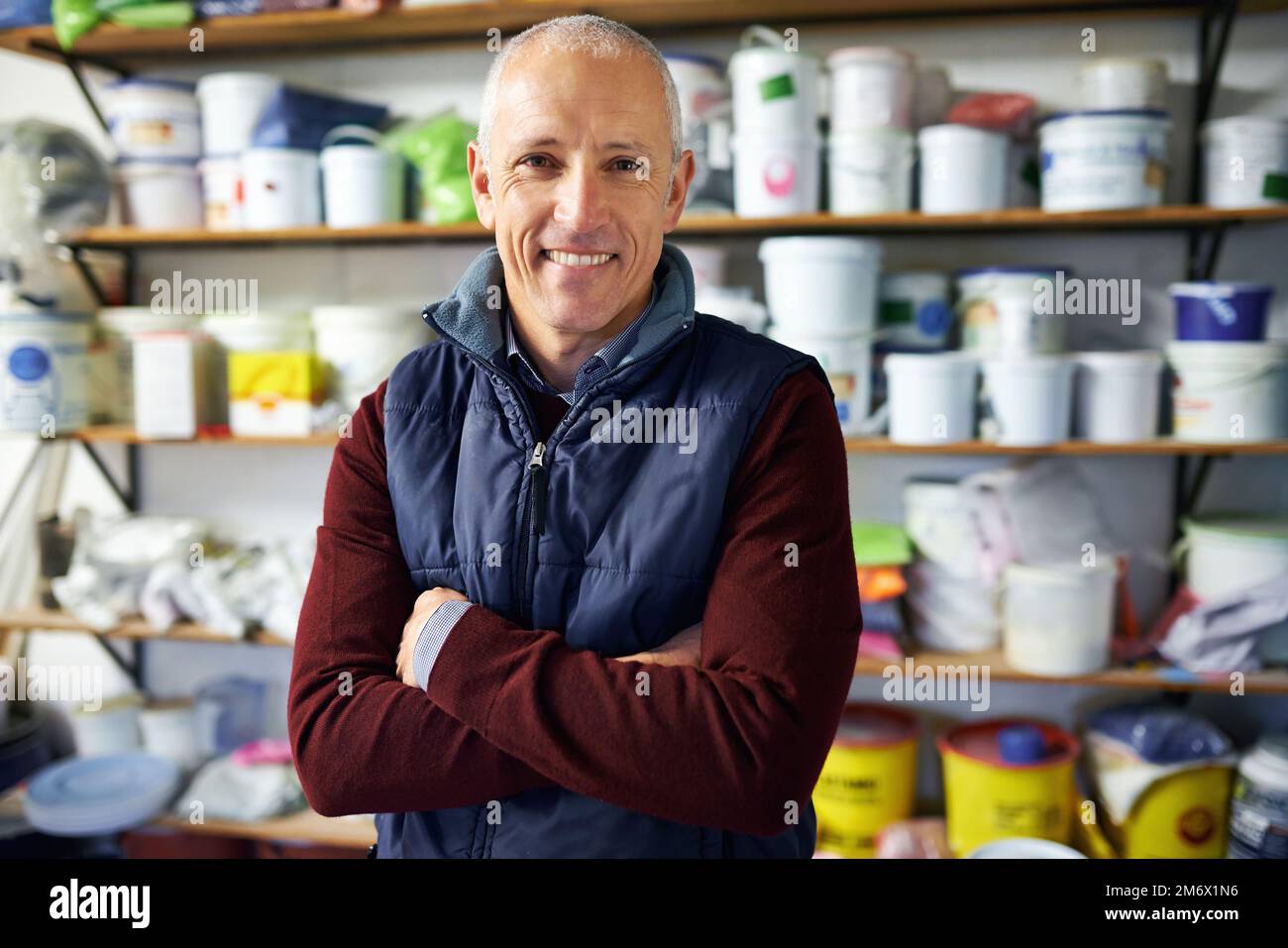 How can I help you today. a store owner standing in front of his