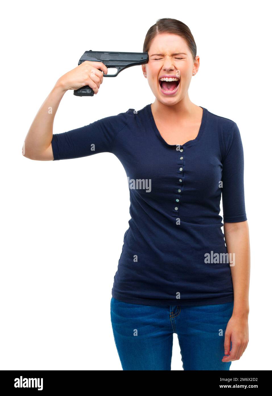 Control your anger before it leads to danger. Studio shot of a young woman pointing a gun at her head isolated on white. Stock Photo