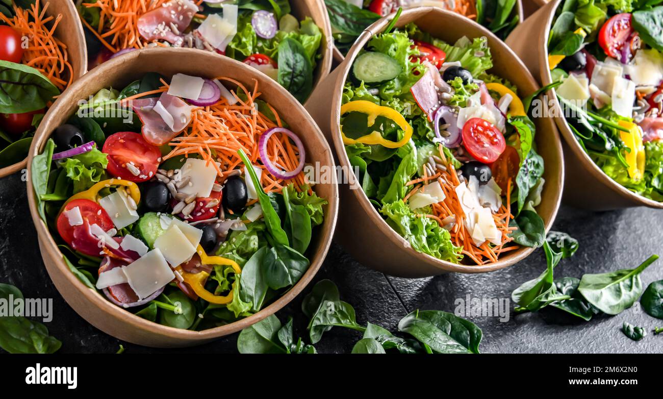Round paper boxes with prepackaged vegetable salads ready for sale