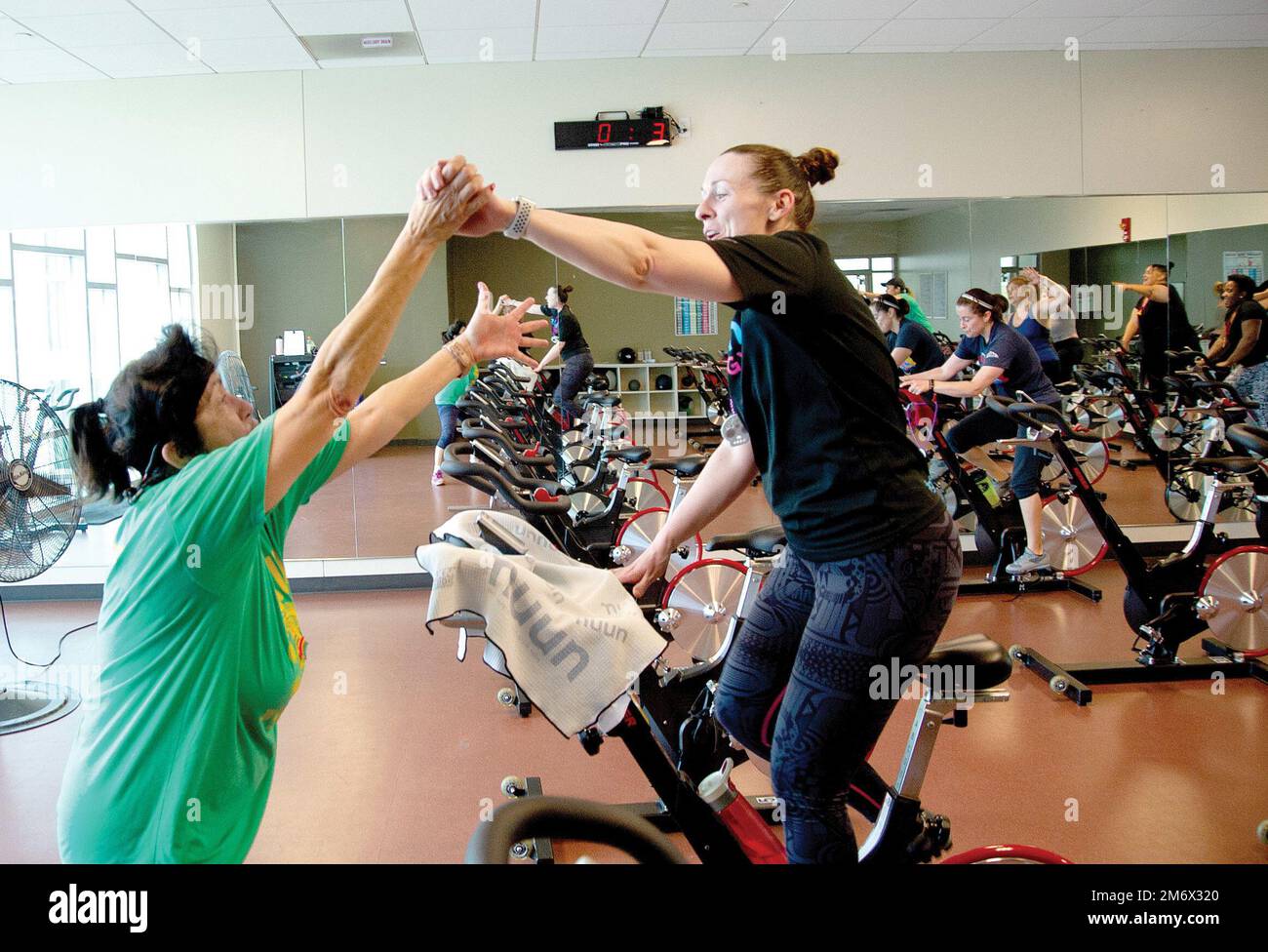 FORT CARSON, Colo. -- Fort Carson spin instructor Lorraine Thorson encourages participants during the Cinco de Mayo spin class May 7, 2022. (Photo by Walt Johnson) Stock Photo