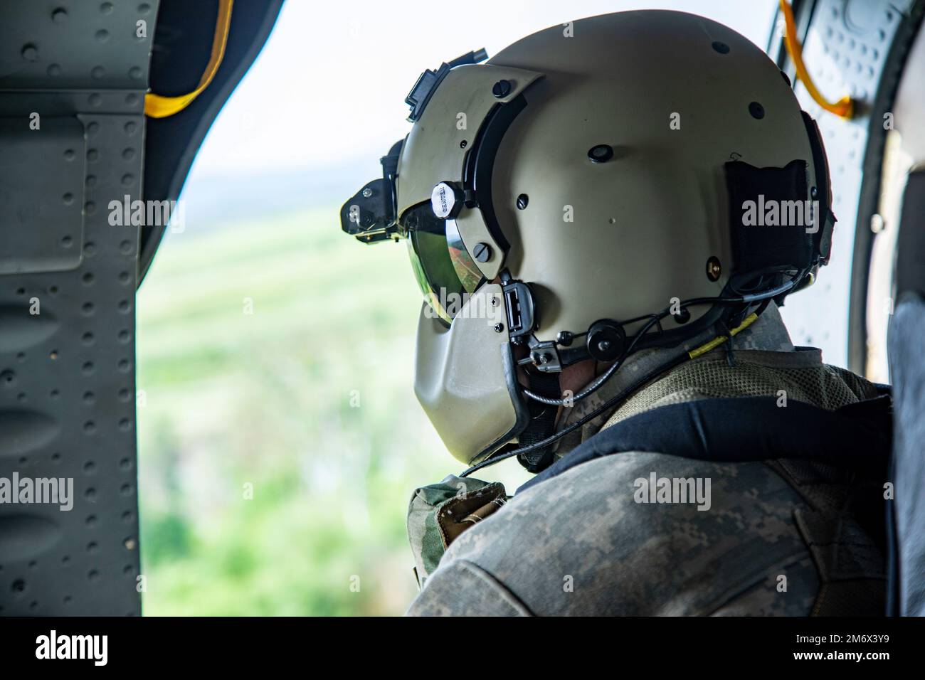 Spc. Eric Griswold, UH-60 Blackhawk Crew member assigned to 2-227th General Support Aviation Battalion, 1st Air Cavalry Brigade participates in an air assault training mission during Swift Response, Krivolak Military Training Center, North Macedonia, May 8, 2022. Exercise Swift Response 2022 is an annual multinational training exercise, which takes place in Eastern Europe, the Arctic High North, Baltics, and Balkans from May 2-20, 2022. It aims to present combat credible Army forces in Europe and Africa and enhance readiness by building airborne interoperability with Allies and Partners and th Stock Photo