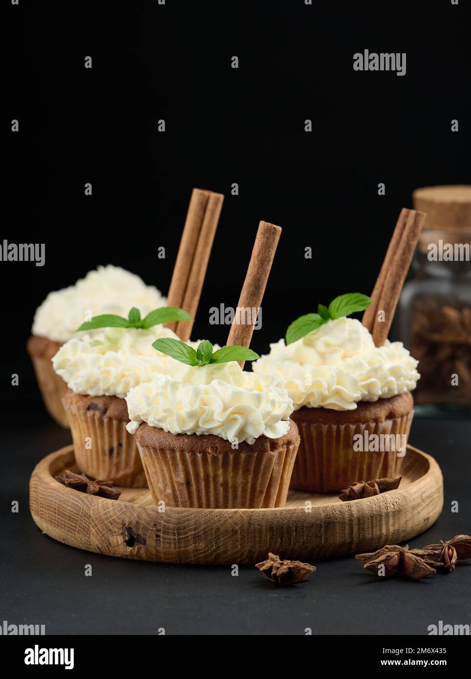 Baked cupcakes with white butter cream on the table, delicious dessert Stock Photo
