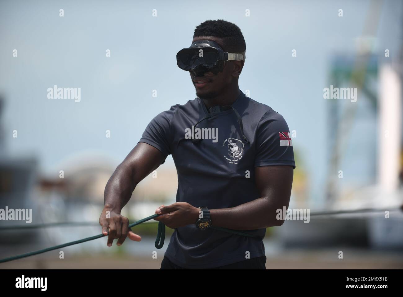 A member of the Trinidad and Tobago coast guard dive team practices line signaling techniques during the Tradewinds 2022 exercise in Belize City, Belize, on May 8, 2022. Line signals are used to establish communications between the dive supervisor and diver when no other means are available. Stock Photo