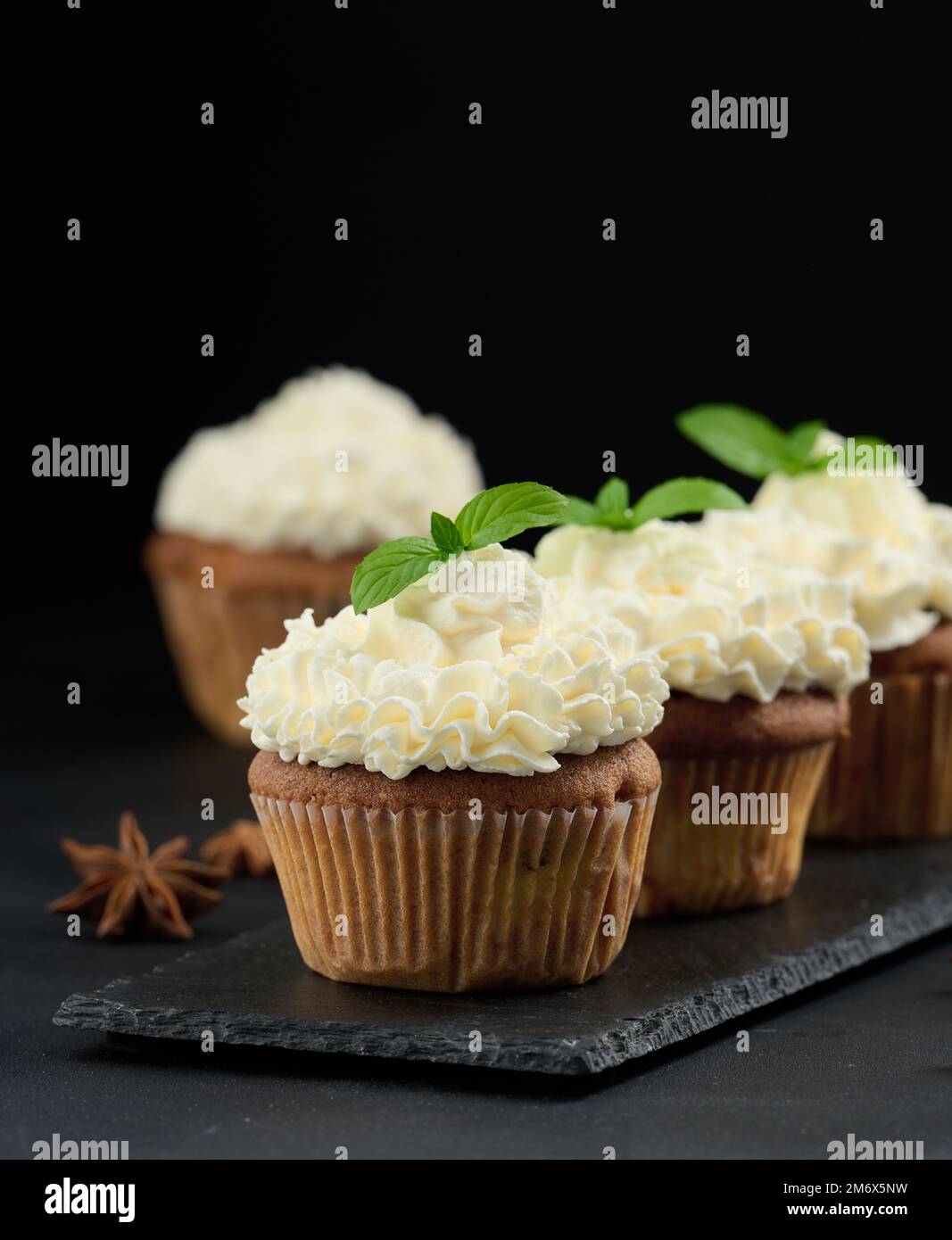 Baked cupcakes with white butter cream on the table, delicious dessert Stock Photo