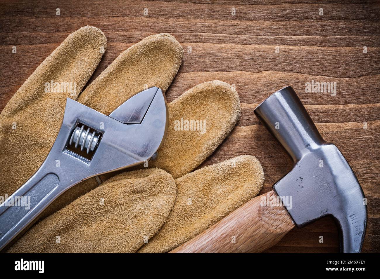 Adjustable spanner claw hammer safety gloves construction concept Stock