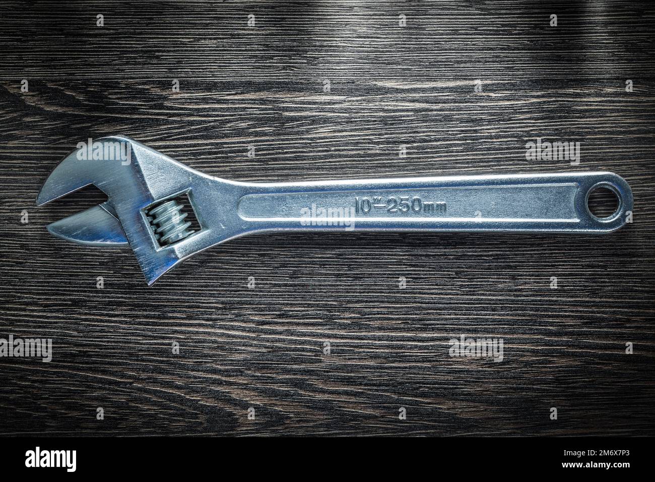 Adjustable wrench on wooden board. Stock Photo