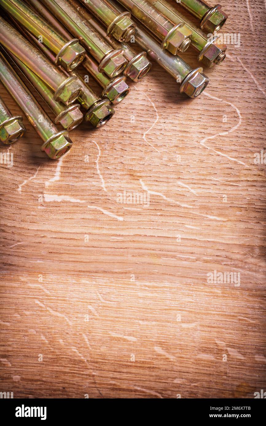 anchors for concrete wall on wooden board with organized copyspace Stock Photo
