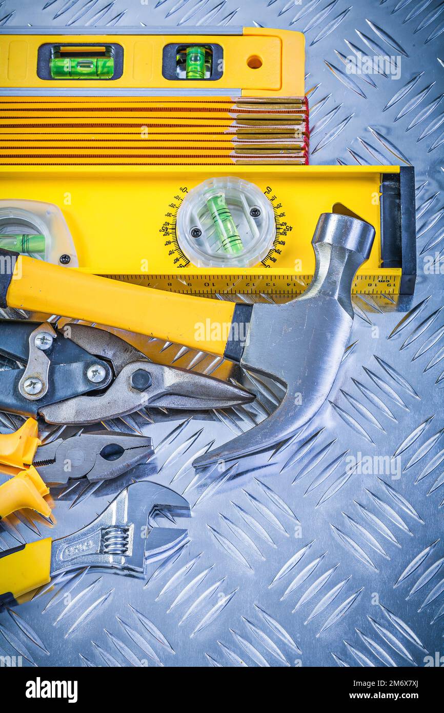 Assortment of construction tooling on channeled metal background