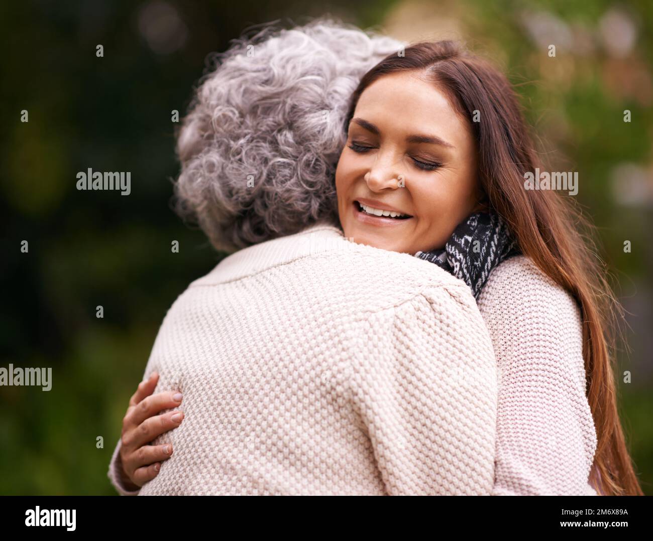 The special love between a mother and daughter. a woman embracing her senior mother outdoors. Stock Photo