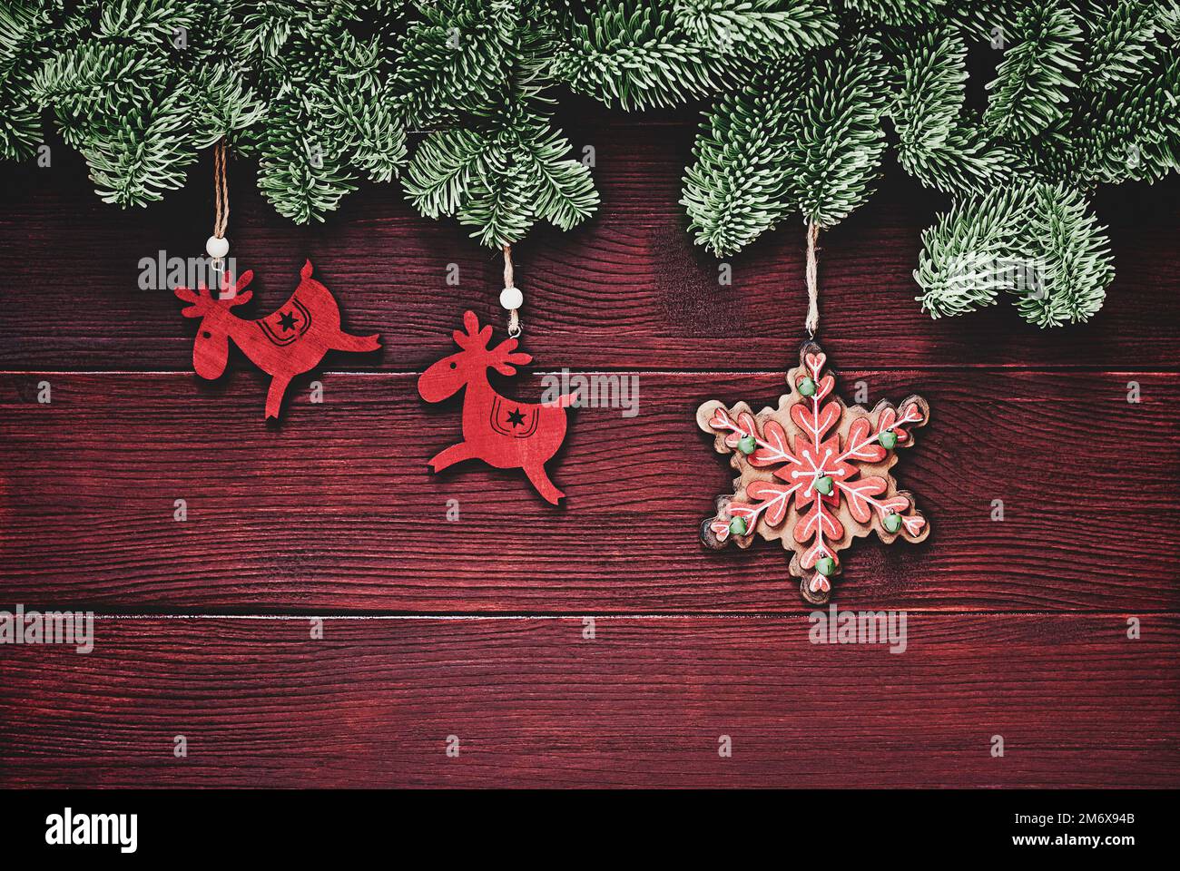 Winter holidays traditional ornaments, christmas background with spruce twigs border, deers and snowflake decorations Stock Photo
