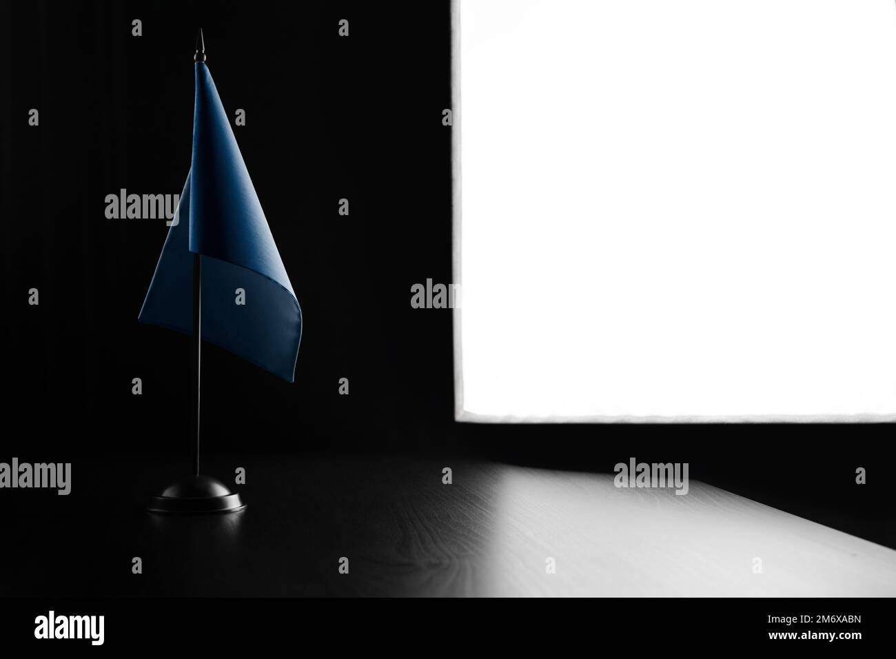 Small national flag of the World Health Organization WHO on a black ...
