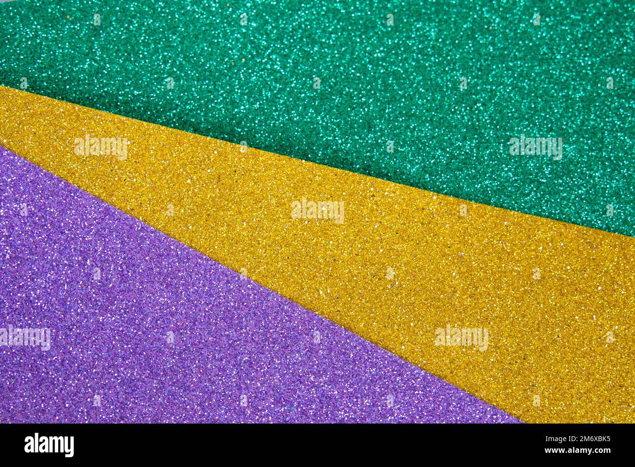 Colorful Mardi gras beads background. Green, purple and gold Merdi