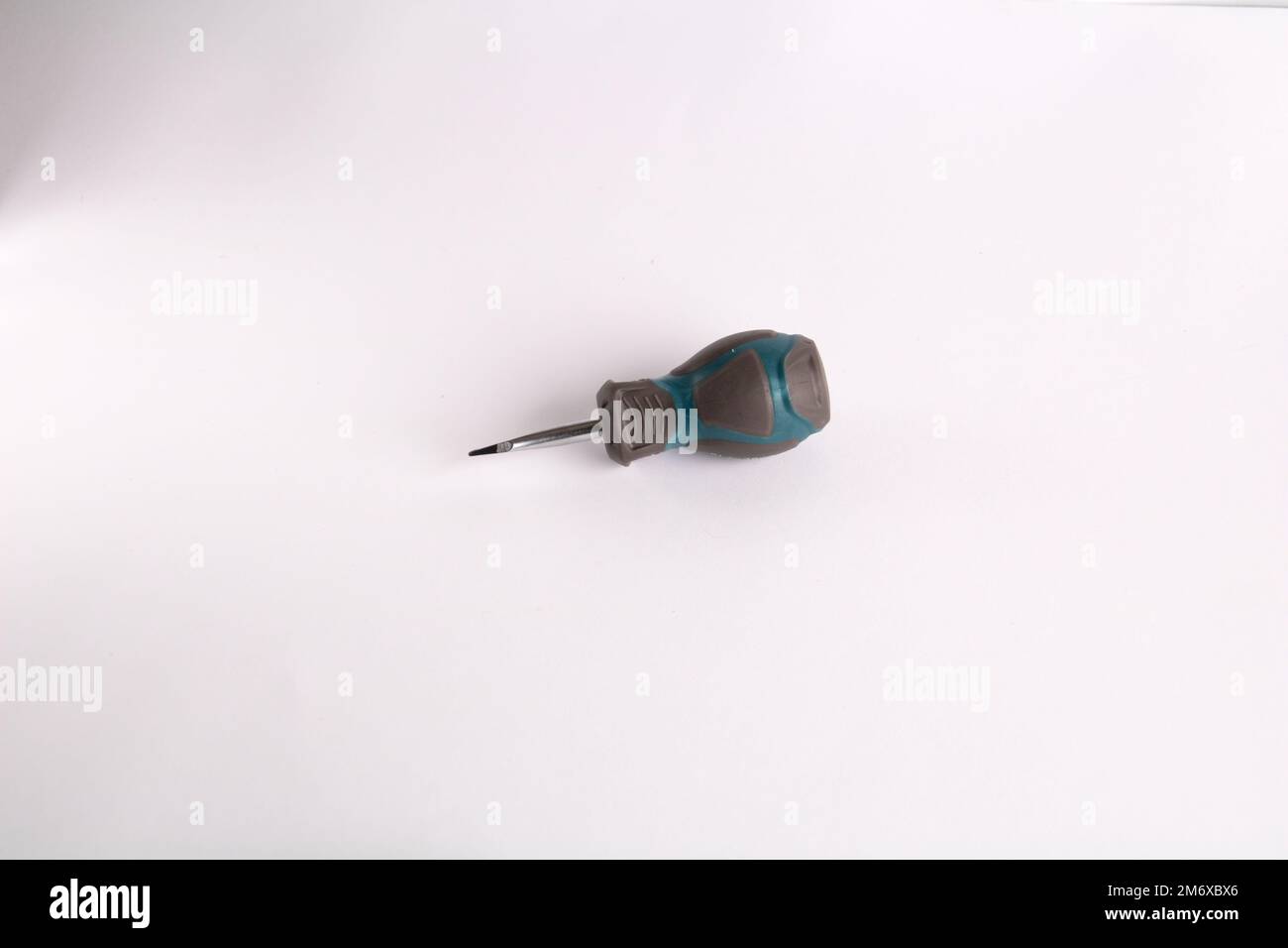photo small screwdriver lying on a white background Stock Photo