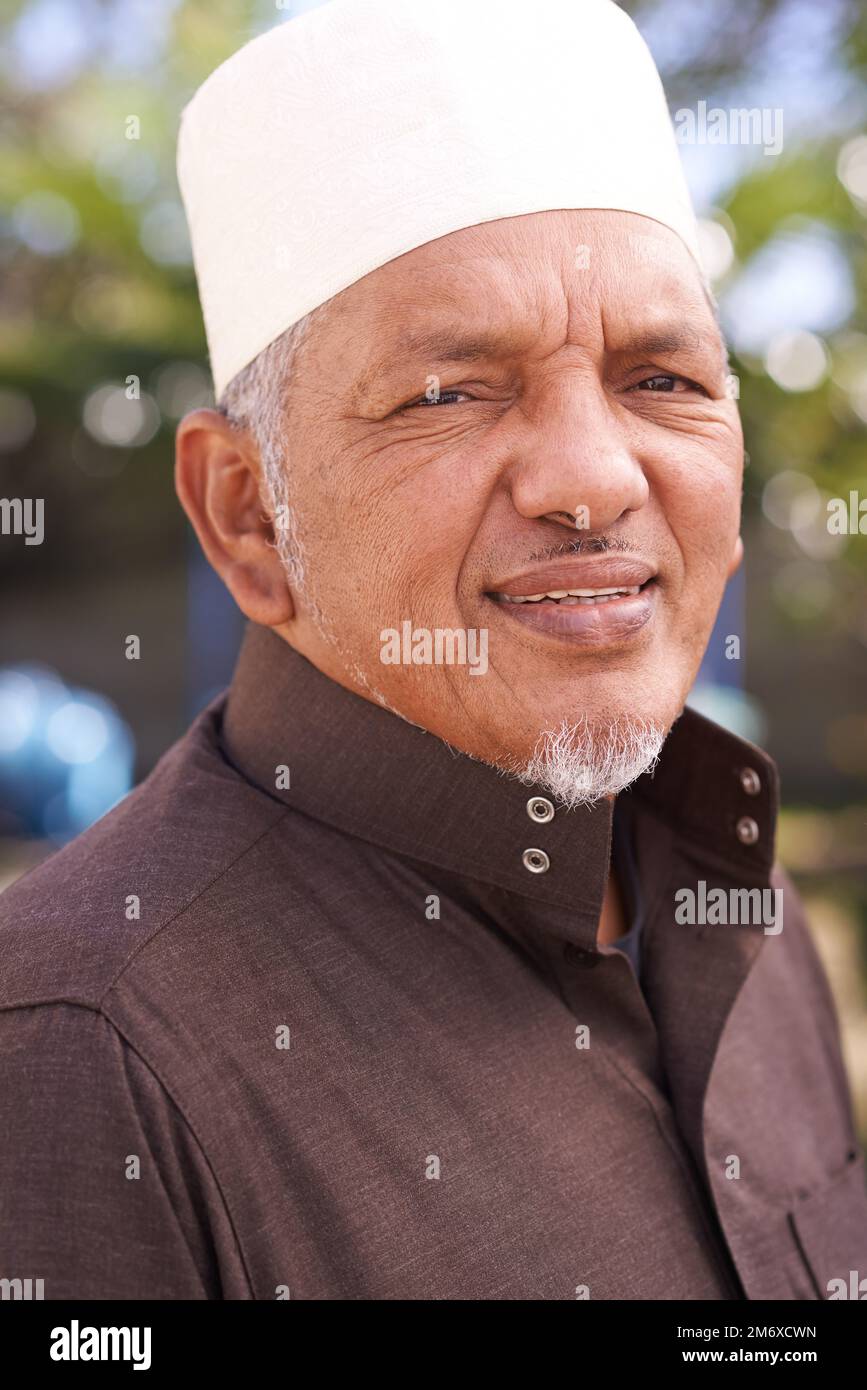 Make sure you get my best side. Portrait of a mature muslim man standing outside. Stock Photo